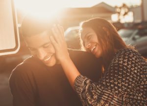 Guy and Girl having fun with a sunset